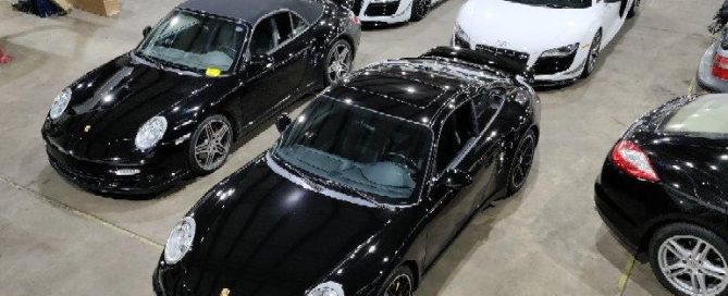 Black Porsche and white Audi R8s at Euro repair shop