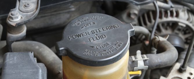 Power steering fluid reservoir cap with "POWER STEERING FLUID" text