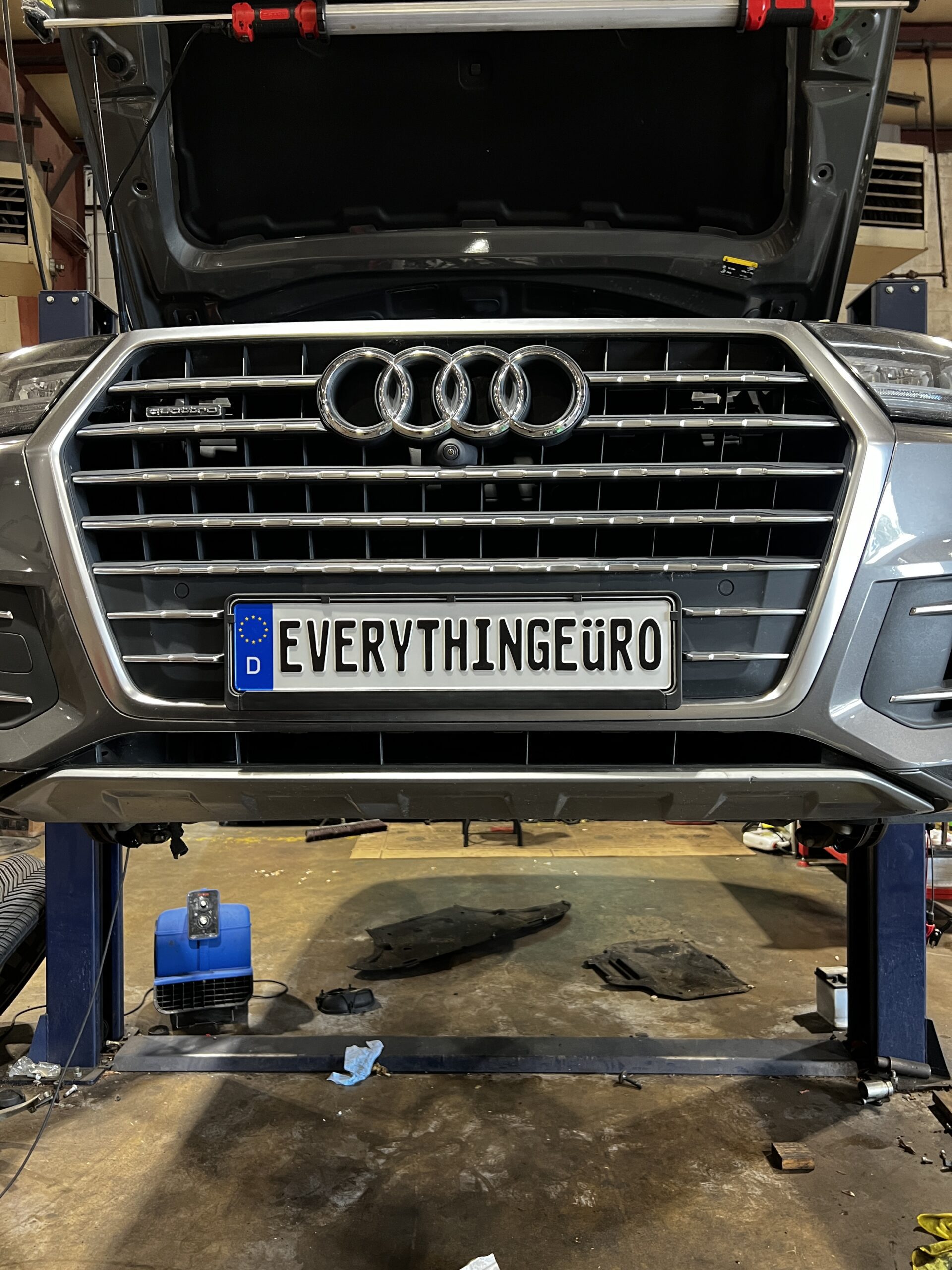 Audi Q7 on a lift at Everything Euro, license plate reads "EVERYTHINGEURO