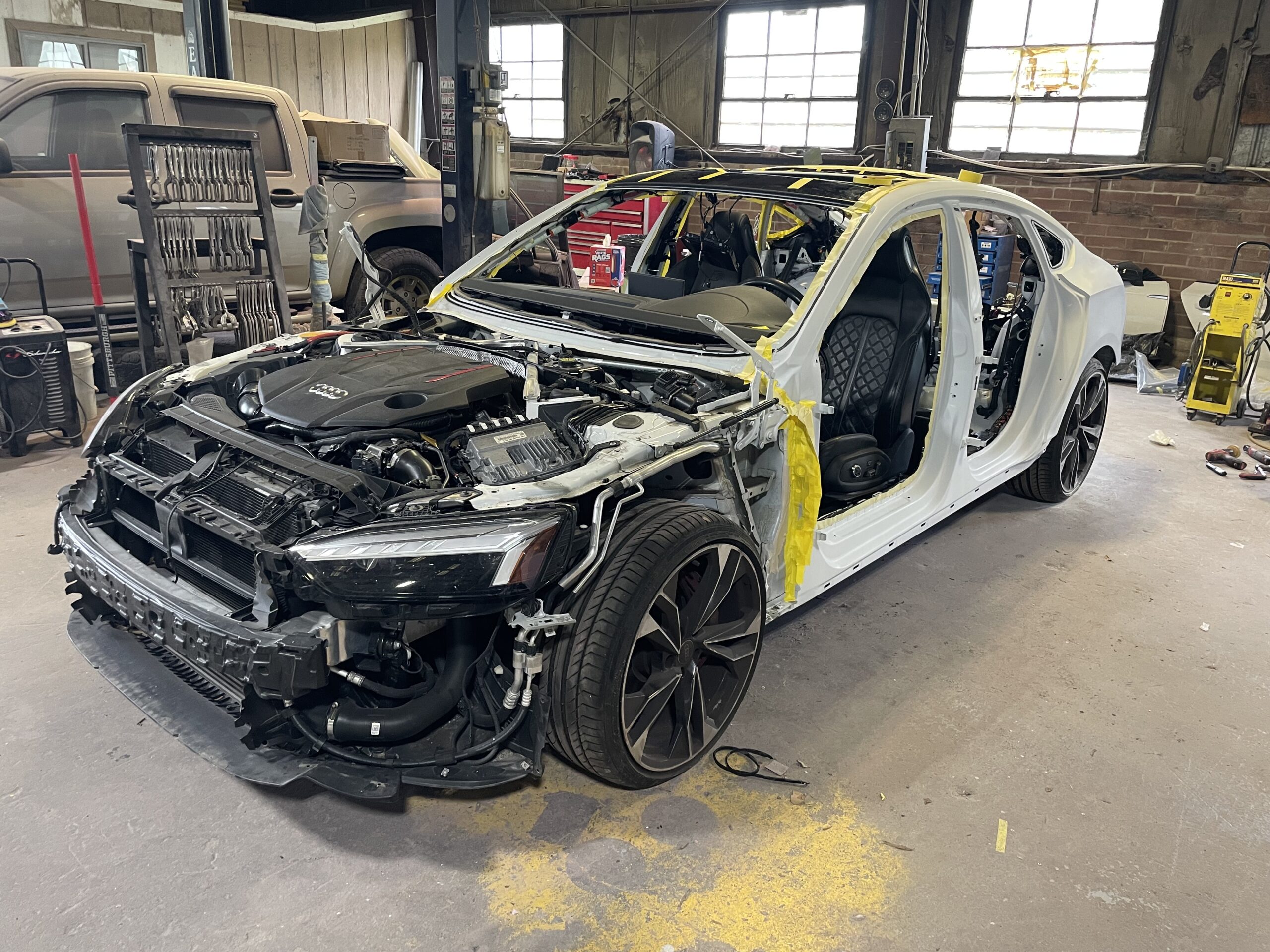 Audi RS5 in repair shop, stripped down for euro auto repair