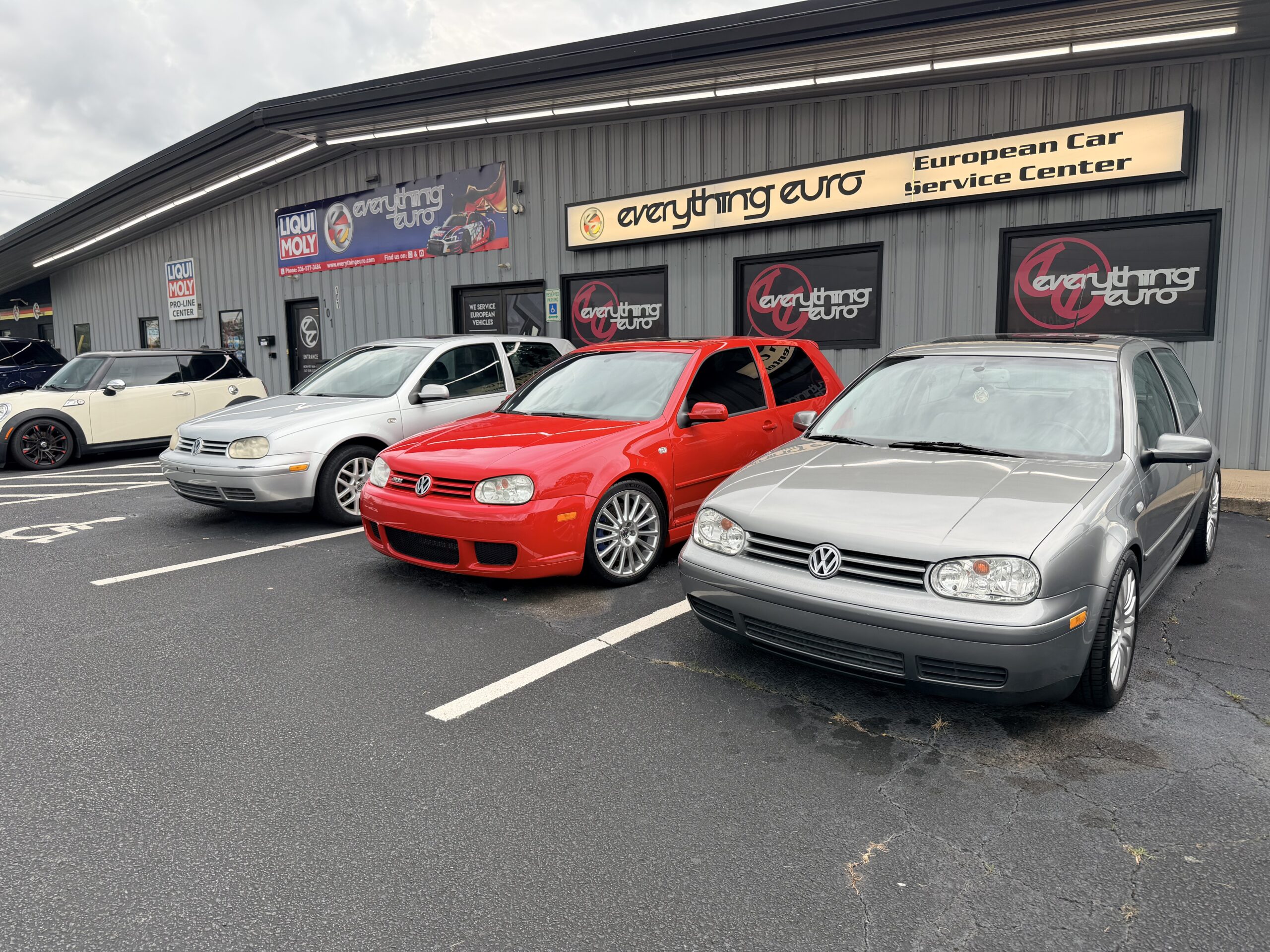 Everything Euro: Silver and red VWs outside European car repair shop
